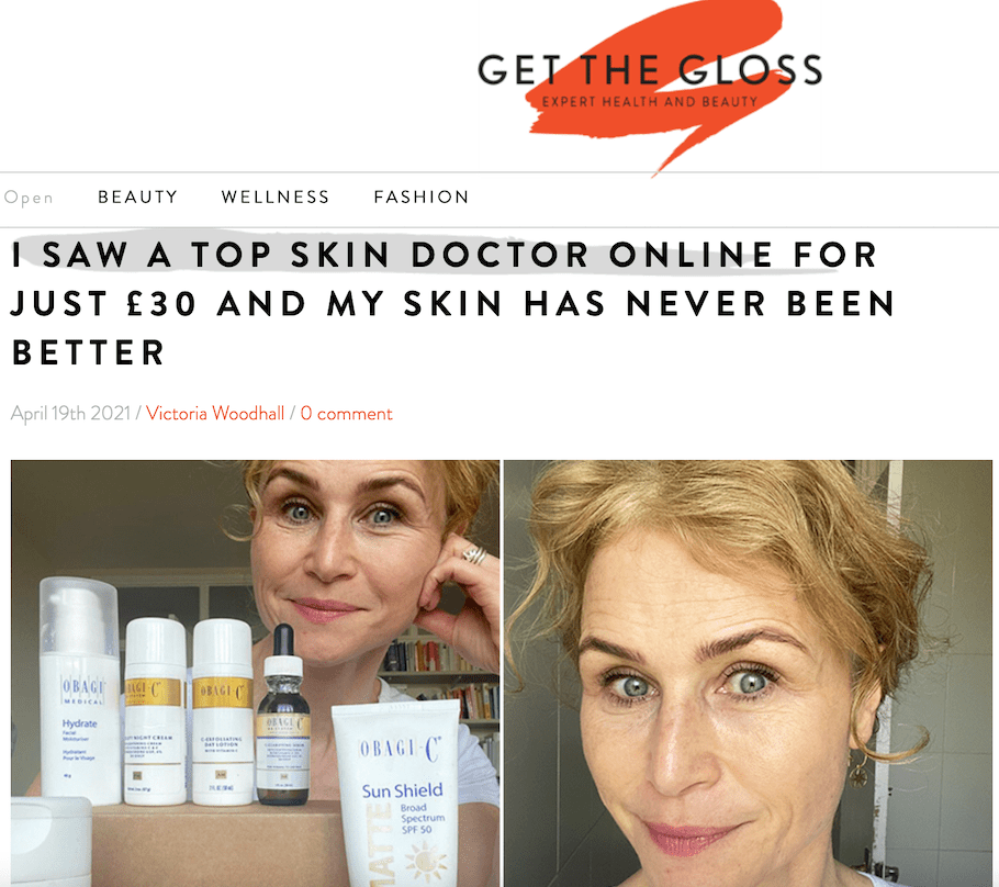 A woman with short blonde hair smiles and points to her face, standing behind a table displaying various skincare products. The article headline above reads, I saw a top skin doctor online for just £30 and my skin has never been better.