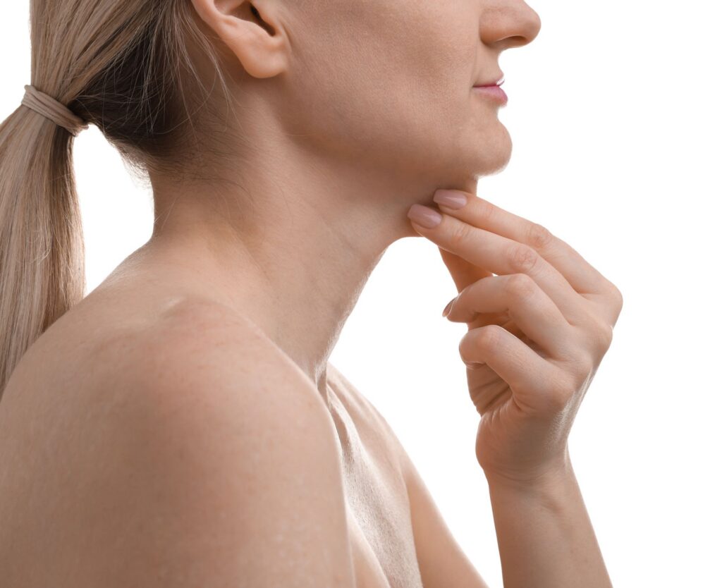 Side profile of a woman resting her fingers under her chin.